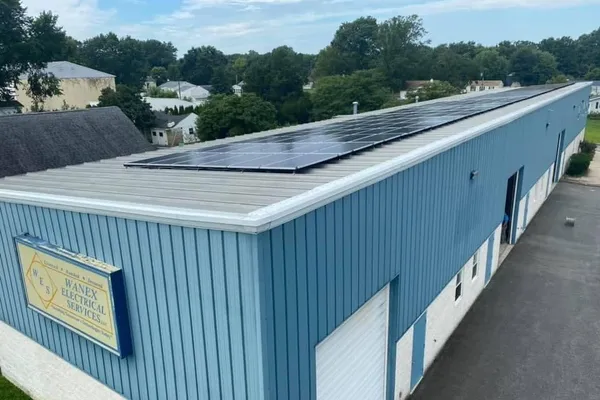 Rooftop solar panel array on Wanex Electrical Services' commercial building